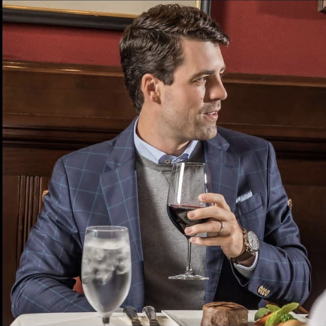 Man in navy check blazer at dinner