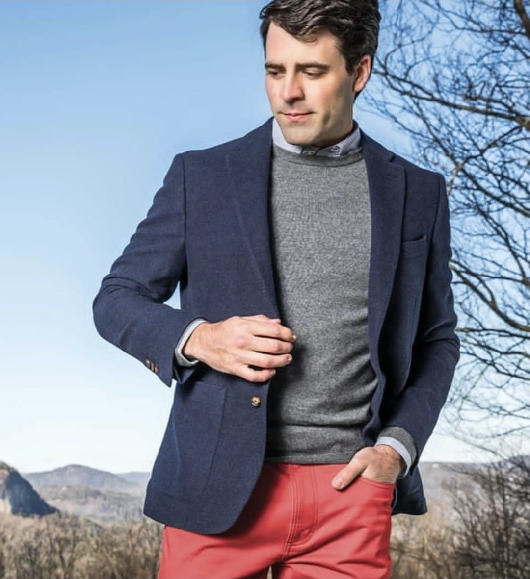 Man wearing navy blazer and coral pants