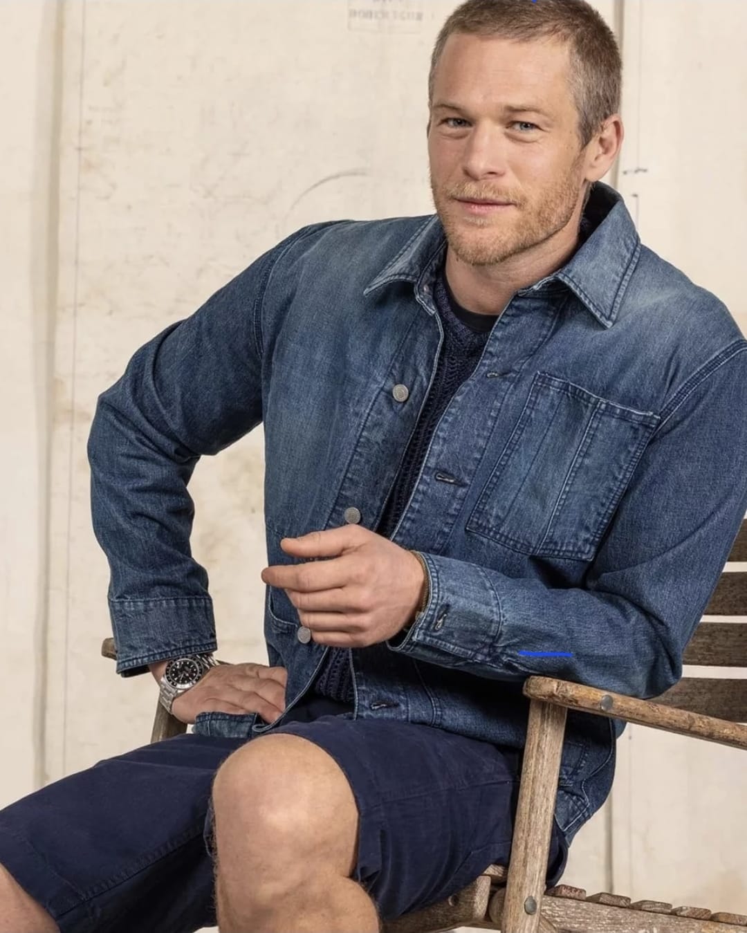 Man wearing denim jacket and shorts